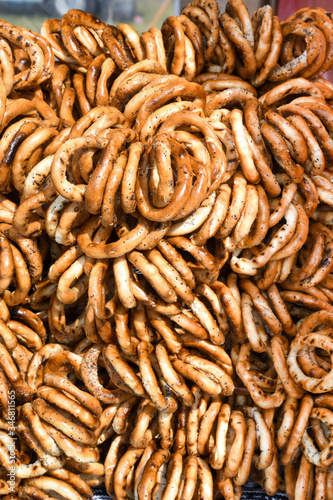 German pretzels stack one over each other, group of thin dry pretzels on rope