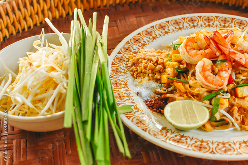 Thai Stir-fried rice noodles (Pad Thai) with shrimp and vegetables. One of the most famous food in Thailand. Thailand traditional dish. photo