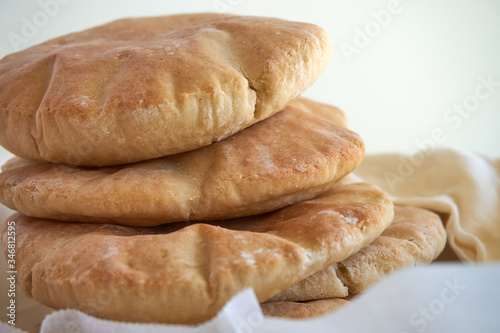 A stack of pita bread on a white background - fresh baked gluten-free pita bread 