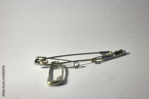safety pins hooked on white background