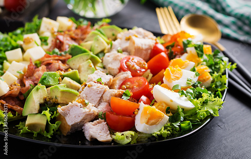 Healthy cobb salad with chicken, avocado, bacon, tomato, cheese and eggs. American food. photo