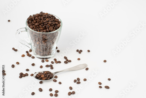 Cup оf coffee , cup with roasted coffee beans and a teaspoon on a white background. Isolate. Space for text.
