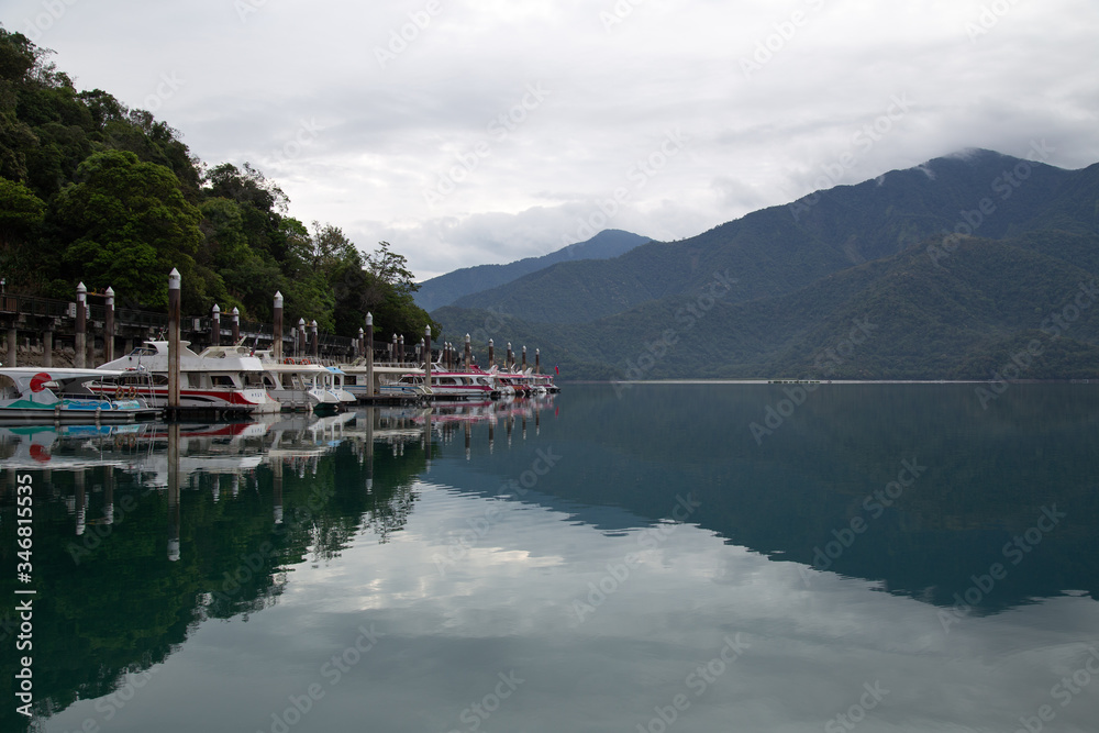Fototapeta premium Beautiful Sun moon lake with mountain view and reflection of mountain on the water. Taiwan