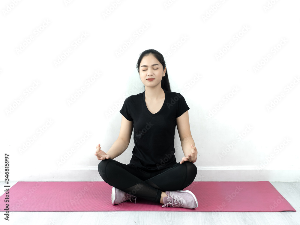 Fototapeta premium Happy Asian sport woman doing yoga on pink mat at home, lifestyle concept