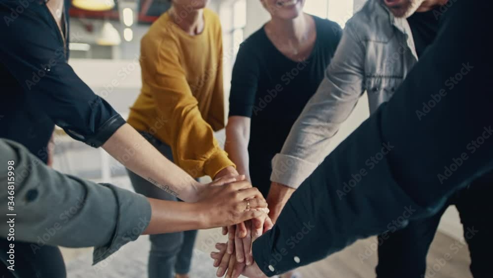 Business team stack hands together and clapping. Group of business people putting their hands together as a symbol of teamwork.
