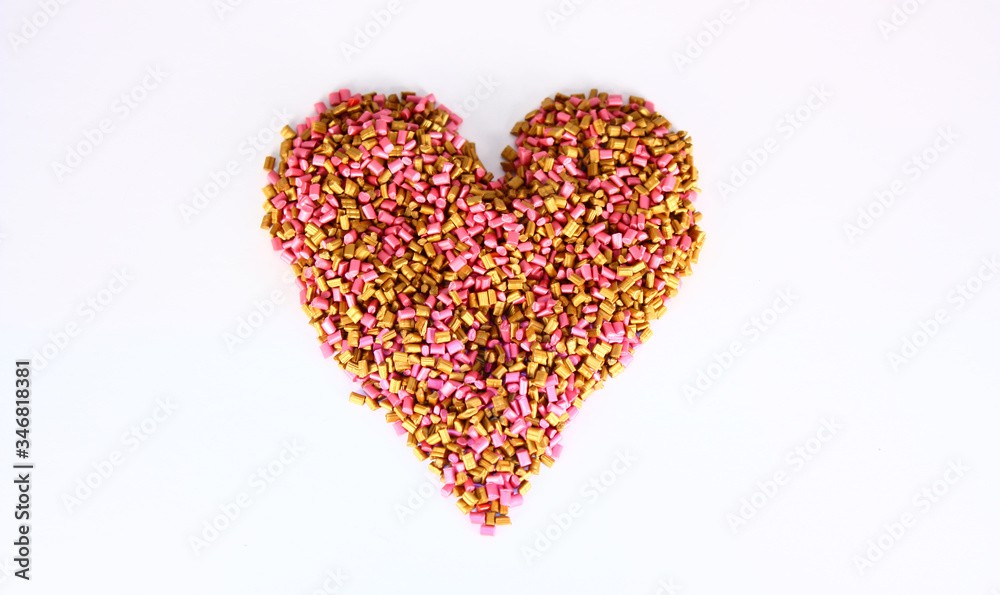 Gold and pink Colored pigment granules were shot on white background.