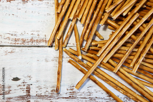 bunch of crispy crunchy salt bread sticks on wooden background close up