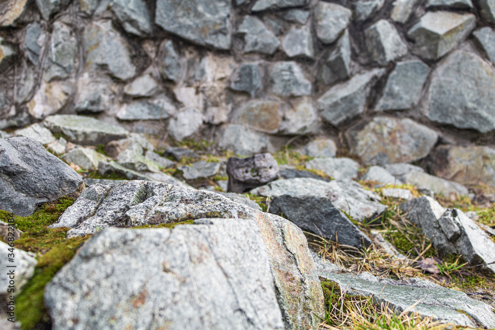 greenish stone with moss and grass on the surface. greenish stone with moss and grass on the surface.
