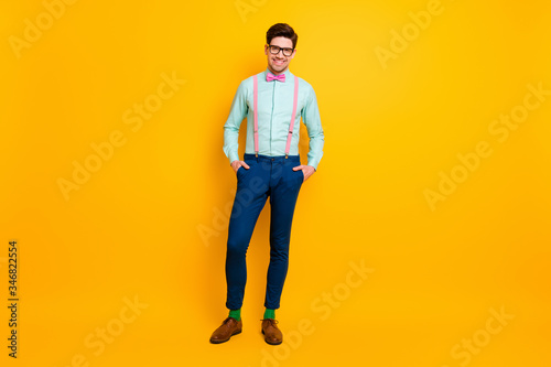 Full size photo of stunning classy content man enjoy summer free time holiday put hands pocket wear stylish bowtie shoes isolated over bright shine color background