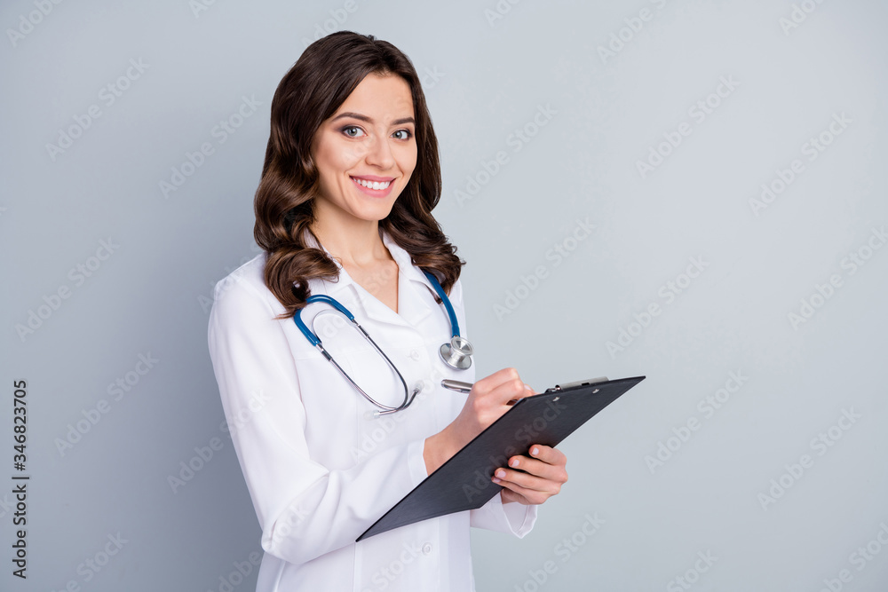Photo of attractive family doc lady professional hold patient medical prescriptions writing medicare pills to insurance list wear white lab coat stethoscope isolated grey color background Photo of attractive family doc lady professional hold patient medical prescriptions writing medicare pills to insurance list wear white lab coat stethoscope isolated grey color background