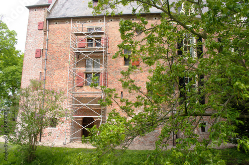 Facade of an ancient castle called Kinkelburg with scaffolding for restore works in Bemmel, Netherlands photo