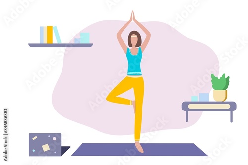 Online yoga and fitness at home.  Woman or girl doing exercises with online instructor at laptop. Healthy lifestyle and relaxation during epidemic. 
