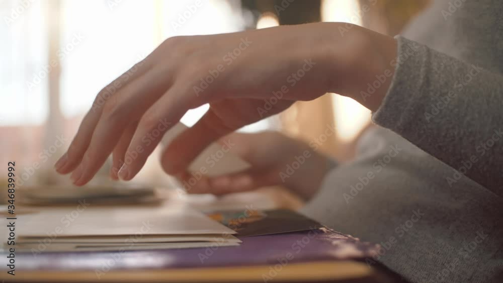 A woman looks at an old photo album, revises photographs and recalls the past. A woman looks at an old photo album, revises photographs and recalls the past.
