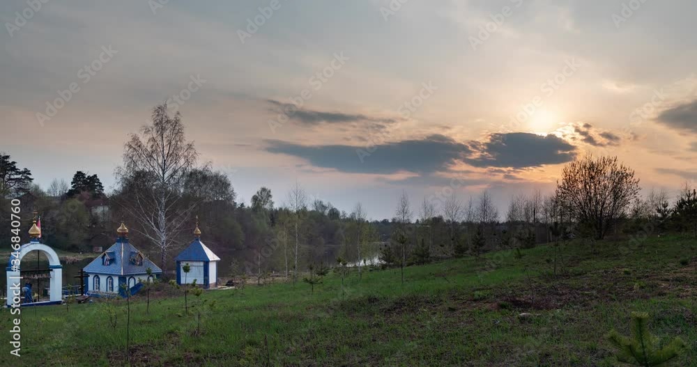 Clouds fly over the field and the church Clouds fly over the field and the church