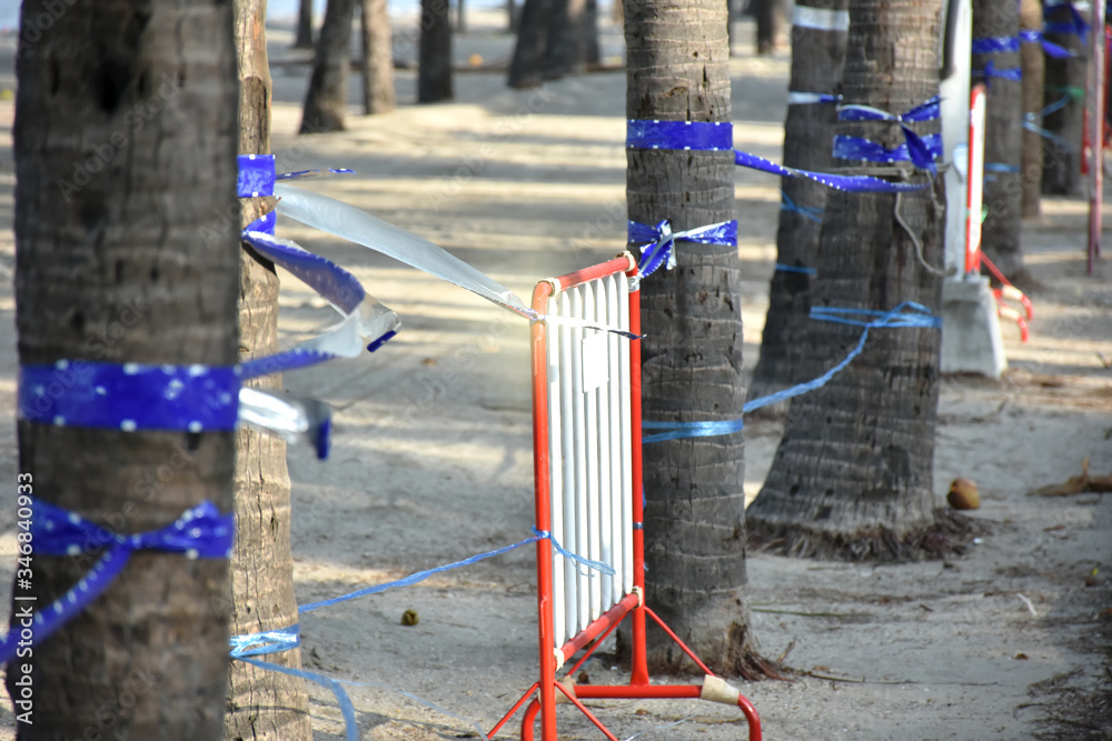 Fototapeta premium Traffic Barrier made of red iron placed on beach area for protection and ban to people use beach area. Protection to spreading from coronavirus concept.