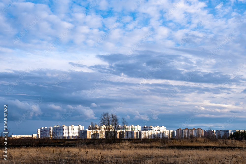 High-rise buildings of the Sukhovka microdistrict in the city of Ivanovo in the rays of the setting sun. High-rise buildings of the Sukhovka microdistrict in the city of Ivanovo in the rays of the setting sun.