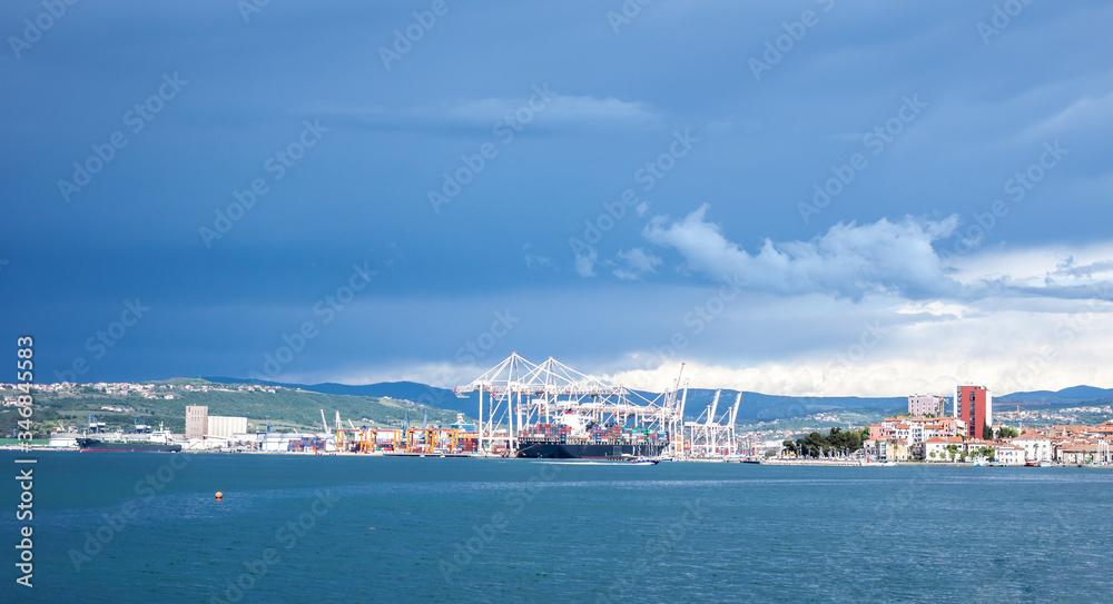 dramatic dark blue stormy sky over cargo port