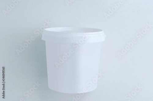 White closed paint bucket on white background. View from above.