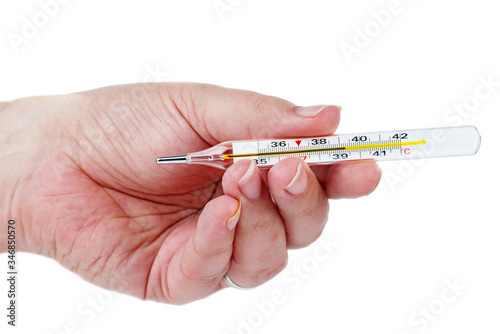 Mercury thermometer in hand isolated. High temperature