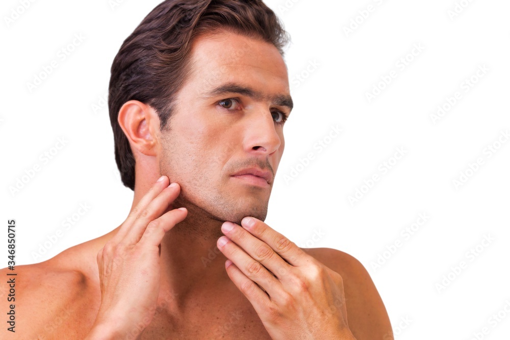 Fototapeta premium Cutout of attractive man checking his face in the mirror