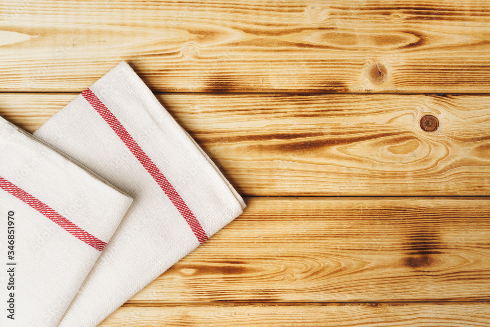 Kitchen towel or napkin over the wooden table. Close up.