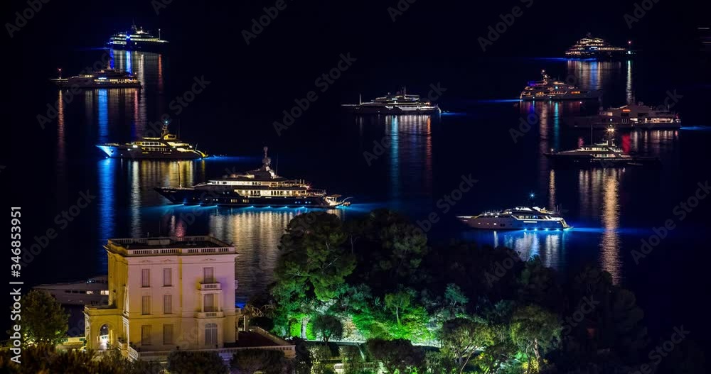 Monaco, Monte-Carlo, Time lapse of many sailyachts and motor boat, parking in the bay, party on boats, quickly carrying by boats, night illumination, tall masts, multi colored