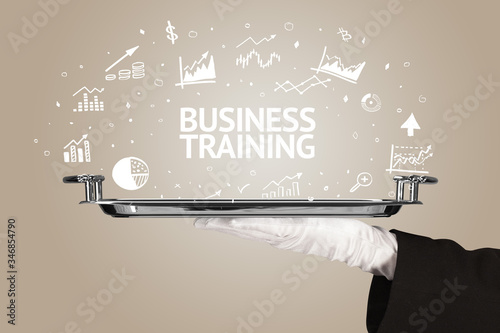 Waiter serving business idea concept with BUSINESS TRAINING inscription