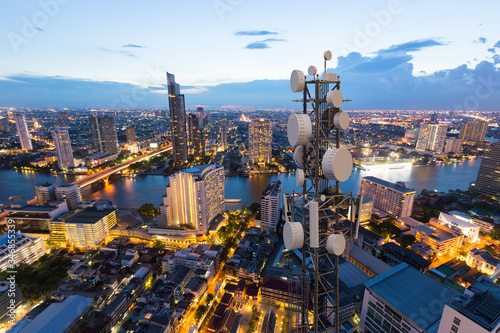 Fototapeta Naklejka Na Ścianę i Meble -  Telecommunication tower with 5G cellular network antenna on city background
