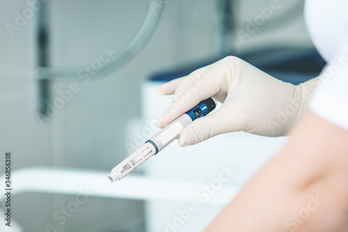 Doctor's hands in gloves with a syringe with an injection or a vaccine close up