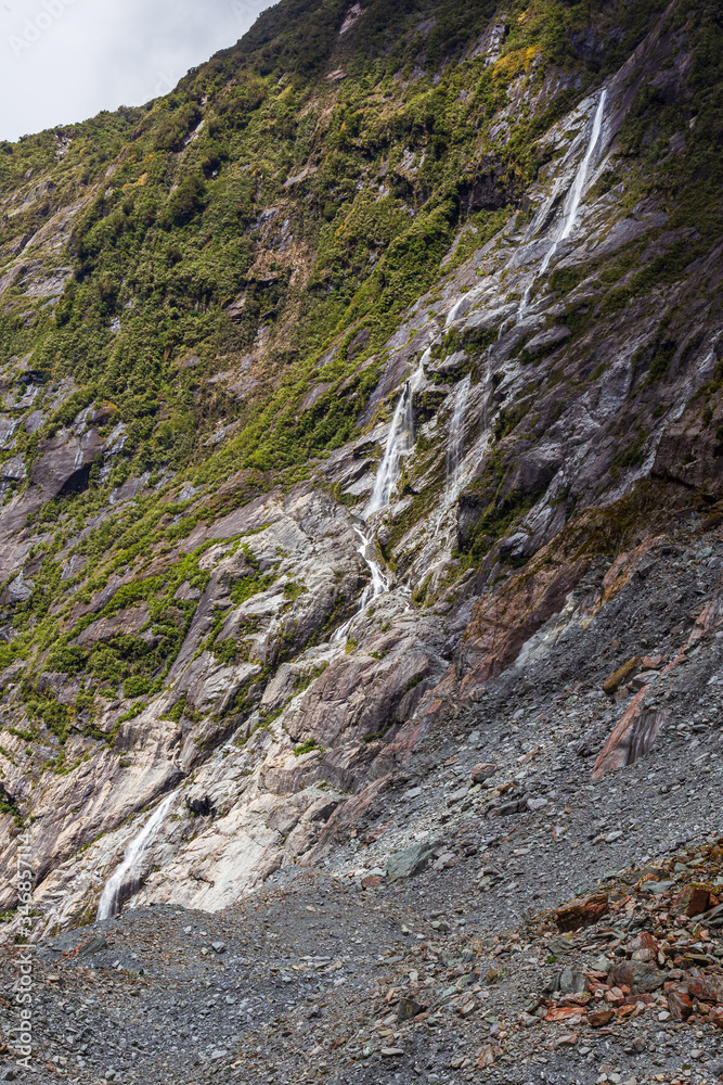 Ice and small waterfall. Franz Joseph Glacier. South Island, New Zealand