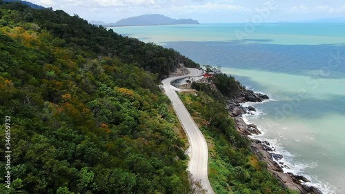 Wallpaper Mural Aerial view of the road beside the blue sea at southern of thailand. with autumn mountain in summer season. smooth drone shot. Torontodigital.ca