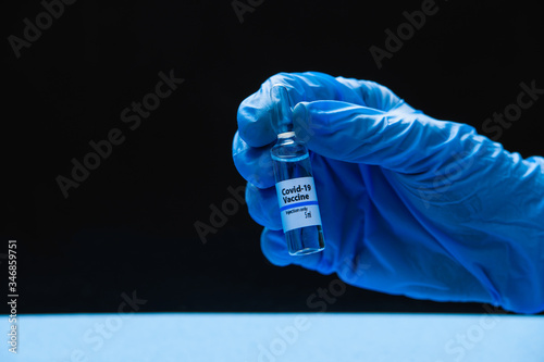 Covid 19 coronavirus vaccine ampoule in the hands of a doctor