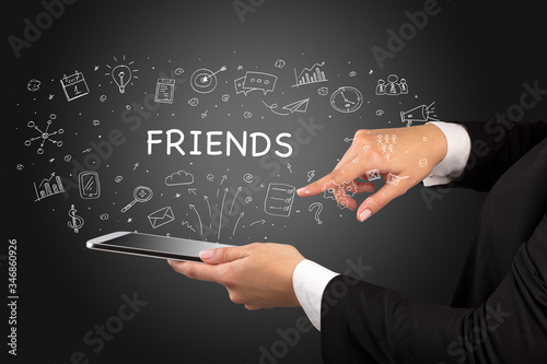 Close-up of a touchscreen with FRIENDS inscription, social media concept