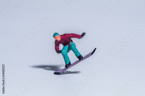 miniature figuire snowboarder jumping in the air