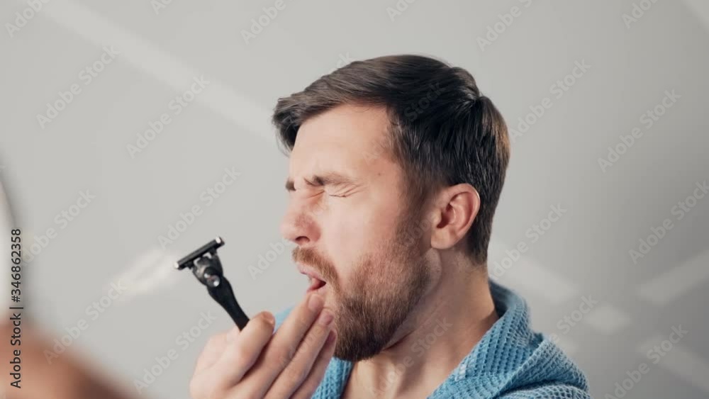 A young man can't shave with a razor hurts him A young man can't shave with a razor hurts him