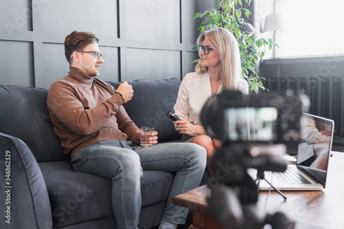 Reporter taking interview recording video for media