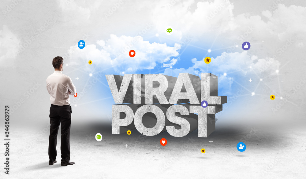 Young businessman standing in front of VIRAL POST inscription, social media concept Young businessman standing in front of VIRAL POST inscription, social media concept