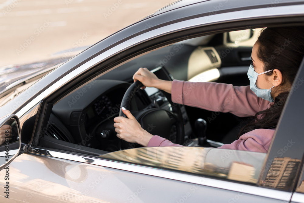 High view woman wearing medical mask and driving