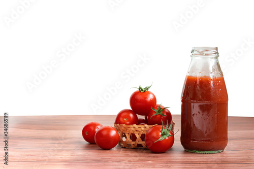 Tomato Juice and Organic Fresh Tomatoes in Basket on Wooden Floor, Isolated White Background with Clipping Path. Healthy Refreshing Beverage 