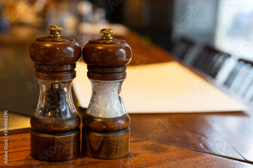 Close up Vintage Wooden Style Salt and Pepper Shaker on Wooden Counter Bar in Japanese Syyle Steak (Teppanyaki) Restaurant photo