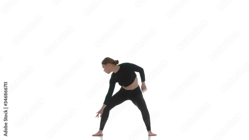 young beautiful woman dancer in black short top and black leggings emotionally dancing contemporary, modern ballet dance, isolated, slow motion young beautiful woman dancer in black short top and black leggings emotionally dancing contemporary, modern ballet dance, isolated, slow motion