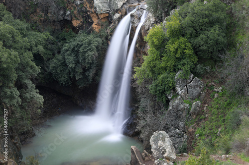Fototapeta Naklejka Na Ścianę i Meble -  High waterfall and greenery all around. Long exposure photography.