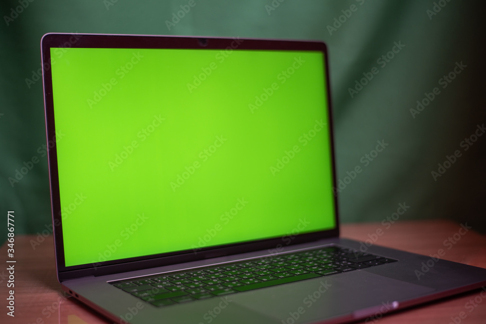 Laptop with green screen on table in work space concept. Laptop with green screen on table in work space concept.
