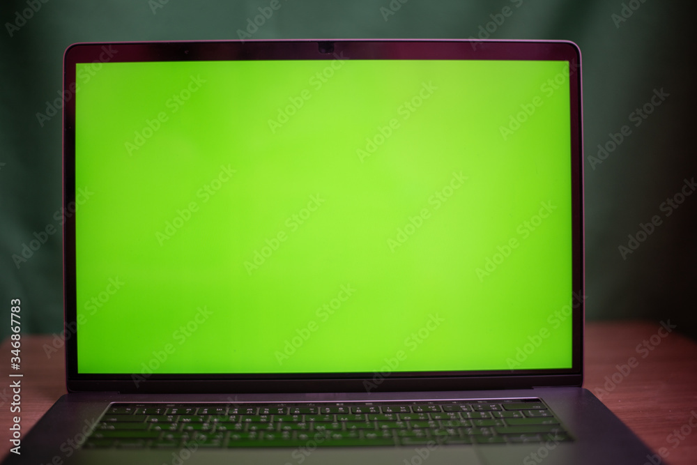 Laptop with green screen on table in work space concept. Laptop with green screen on table in work space concept.