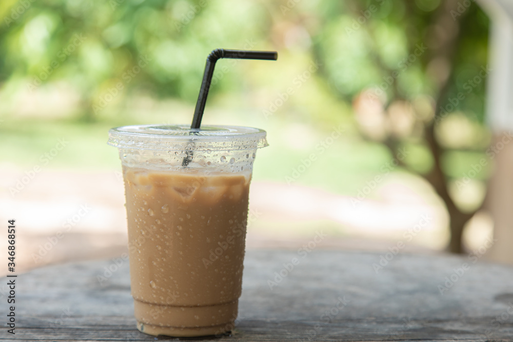 Iced coffee on cup on wooden nature background Iced coffee on cup on wooden nature background
