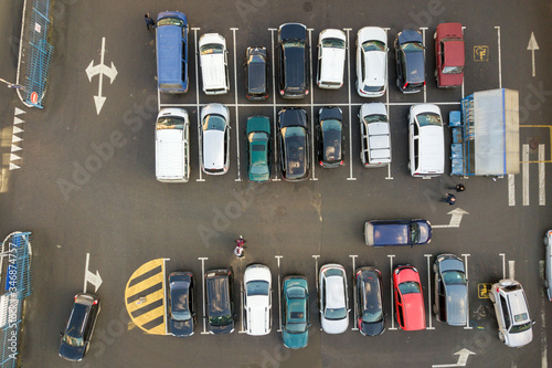Top view of many cars parked on a parking lot.