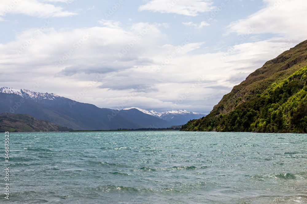 Beauty of New Zealand. Wanaka lake. Snow and cliffs, stones and water. South Island