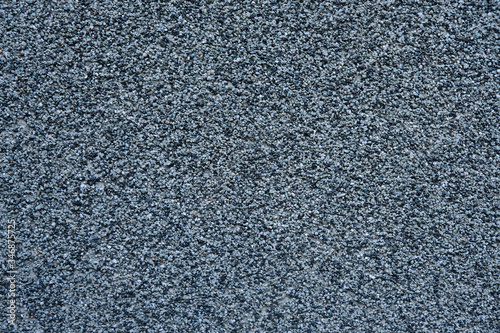 Wall made of small black and grey stones backgrounds.