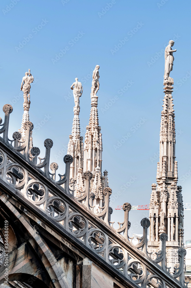 Ornate marble statues on the roof of famous Cathedral Duomo in Milan, Lombardy, Italy Ornate marble statues on the roof of famous Cathedral Duomo in Milan, Lombardy, Italy