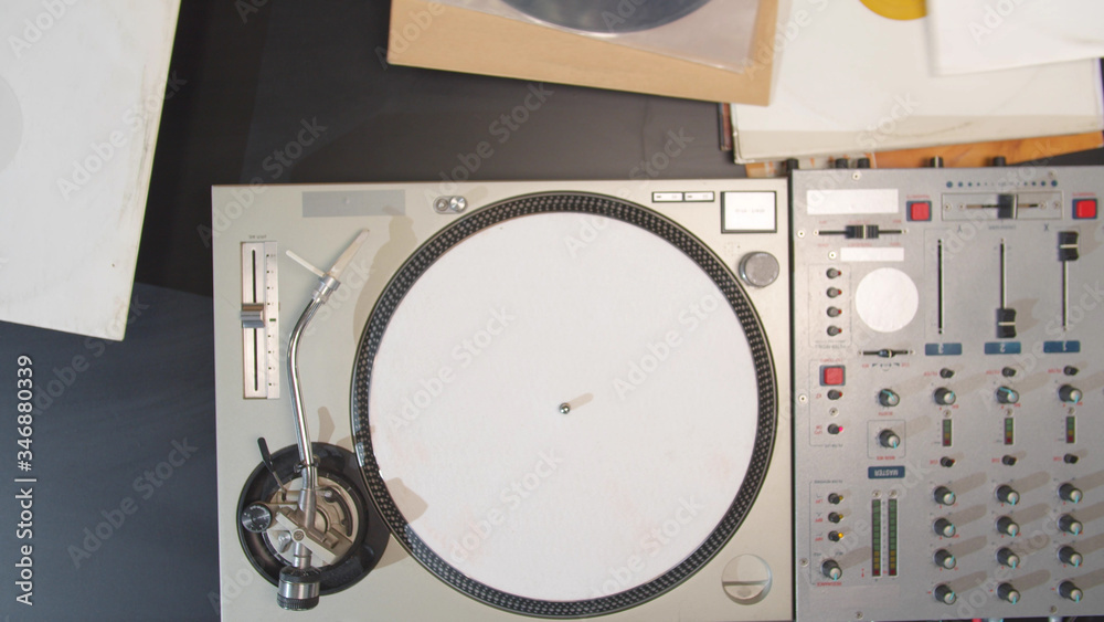 Fototapeta premium The musician examines vinyl records. Top view